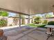 Covered patio with a view of a landscaped backyard with artificial grass at 7892 Nookfield Dr, Las Vegas, NV 89147