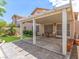 Covered patio area extending to artificial grass, great for outdoor living at 7892 Nookfield Dr, Las Vegas, NV 89147