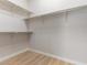 Walk-in closet with wooden floor and multiple levels of shelving at 7892 Nookfield Dr, Las Vegas, NV 89147