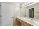 Bathroom sink and vanity with large mirror and accessible handrail at 8901 Litchfield Ave, Las Vegas, NV 89134