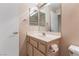 Bright bathroom with single sink vanity, framed mirror, and great lighting at 8901 Litchfield Ave, Las Vegas, NV 89134
