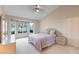 Light-filled bedroom boasts bay windows and a stylish ceiling fan at 8901 Litchfield Ave, Las Vegas, NV 89134