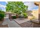 Charming front courtyard featuring a cozy seating area and lush landscaping at 8901 Litchfield Ave, Las Vegas, NV 89134