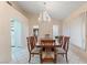Formal dining area featuring a classic wood table, seating for eight, and a decorative chandelier above at 8901 Litchfield Ave, Las Vegas, NV 89134