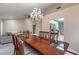 Elegant dining area connects to a living room and kitchen, with a large wooden table set beneath a beautiful chandelier at 8901 Litchfield Ave, Las Vegas, NV 89134