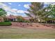 Attractive single story home with meticulous landscaping and a red tile roof set against a blue cloudy sky at 8901 Litchfield Ave, Las Vegas, NV 89134