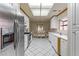 Bright kitchen with stainless steel appliances, white cabinets, and an adjacent breakfast area with a glass table at 8901 Litchfield Ave, Las Vegas, NV 89134