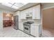 Open kitchen featuring white cabinetry, stainless appliances, granite countertops, and an open view into the dining room at 8901 Litchfield Ave, Las Vegas, NV 89134