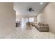 A bright living room with a neutral color palette and tile flooring is spacious with a large sectional sofa at 8901 Litchfield Ave, Las Vegas, NV 89134