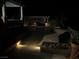 Tranquil backyard oasis at night with a pool, spa, and ambient lighting at 893 Fairway Dr, Boulder City, NV 89005