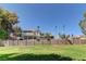 Expansive backyard with lush green grass, mature trees, and stunning views of the home at 893 Fairway Dr, Boulder City, NV 89005
