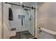 Modern bathroom featuring a subway tile shower, glass door, rain shower head, and a built-in bench at 893 Fairway Dr, Boulder City, NV 89005