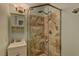 Modern bathroom featuring a tiled shower stall with glass door and vanity with ample storage at 893 Fairway Dr, Boulder City, NV 89005
