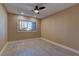 Neutral-toned bedroom with laminate flooring, a window for natural light, and a ceiling fan at 893 Fairway Dr, Boulder City, NV 89005