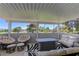 Relaxing covered patio featuring comfortable seating, a fire pit, and a scenic view of the surrounding landscape at 893 Fairway Dr, Boulder City, NV 89005