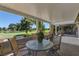 Relaxing covered patio overlooking lush landscaping and a serene water feature at 893 Fairway Dr, Boulder City, NV 89005