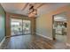 Bright dining area with wood floors and sliding glass doors to the outdoor seating area at 893 Fairway Dr, Boulder City, NV 89005
