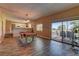 Open-concept game room with hardwood floors, pool table, and sliding glass doors to a covered patio and backyard at 893 Fairway Dr, Boulder City, NV 89005