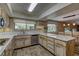 Spacious kitchen with wood cabinets, marble countertops, and modern appliances at 893 Fairway Dr, Boulder City, NV 89005