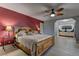 Spacious main bedroom boasts a king-sized bed, ceiling fan, and en-suite bathroom with a double vanity at 893 Fairway Dr, Boulder City, NV 89005