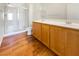 Bathroom features wood cabinets, dual sinks, and a glass-enclosed shower at 8985 S Durango Dr # 2081, Las Vegas, NV 89113