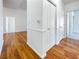 Bright hallway featuring beautiful wood floors, white walls, and white doors to other rooms at 8985 S Durango Dr # 2081, Las Vegas, NV 89113