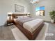 Well lit main bedroom features a ceiling fan and a large window at 8985 S Durango Dr # 2081, Las Vegas, NV 89113