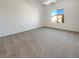Spacious carpeted main bedroom featuring a ceiling fan and a large window at 8985 S Durango Dr # 2081, Las Vegas, NV 89113