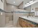 Bathroom featuring neutral tile, a glass-enclosed shower and a vanity with accent tiles at 9000 Las Vegas Blvd # 1004, Las Vegas, NV 89123