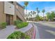 A condo building exterior with stairs leading to the front door and landscaped bushes along the walkway at 9000 Las Vegas Blvd # 1004, Las Vegas, NV 89123