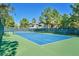 A vibrant blue tennis court surrounded by mature trees offers a recreational amenity for residents to enjoy at 9000 Las Vegas Blvd # 1004, Las Vegas, NV 89123