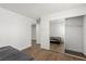 Cozy bedroom with wood floors, a closet with mirrored doors, and neutral tones at 905 Sulphur Springs Ln # 101, Las Vegas, NV 89128