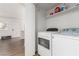 Well-lit laundry room with a washer, dryer, and storage shelf above at 905 Sulphur Springs Ln # 101, Las Vegas, NV 89128