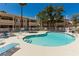 Outdoor community pool and hot tub with lounge chairs and well-maintained landscaping at 905 Sulphur Springs Ln # 101, Las Vegas, NV 89128