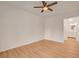 Empty bedroom featuring hardwood floors, ceiling fan and view of ensuite bathroom at 9303 Gilcrease Ave # 1245, Las Vegas, NV 89149
