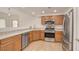 Bright kitchen features stainless steel appliances and wood cabinets at 9303 Gilcrease Ave # 1245, Las Vegas, NV 89149