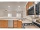 Bright kitchen features stainless steel appliances and wood cabinets at 9303 Gilcrease Ave # 1245, Las Vegas, NV 89149