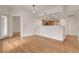 Open-concept living room with wood floors adjacent to kitchen area at 9303 Gilcrease Ave # 1245, Las Vegas, NV 89149