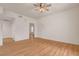 Well-lit living room with wood floors, ceiling fan, and white walls at 9303 Gilcrease Ave # 1245, Las Vegas, NV 89149