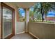 Private patio with views of the community, landscaping, and nearby buildings, accessed through a glass door at 9303 Gilcrease Ave # 1245, Las Vegas, NV 89149