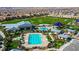 Aerial view of community featuring a pool, clubhouse, sports fields, and playground areas at 10142 Skye Saddle Ave, Las Vegas, NV 89166