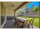 Covered back patio with an outdoor dining set and a view of the green backyard at 10142 Skye Saddle Ave, Las Vegas, NV 89166