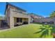 View of the artificial grass backyard with patio and privacy walls at 10142 Skye Saddle Ave, Las Vegas, NV 89166
