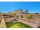Artificial grass and fire pit for outdoor entertaining in a private backyard at 10142 Skye Saddle Ave, Las Vegas, NV 89166