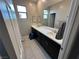 Bathroom with double vanity, sleek countertops, and modern fixtures providing a clean aesthetic at 10142 Skye Saddle Ave, Las Vegas, NV 89166