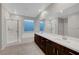 Bright bathroom featuring a glass shower, a soaking tub, a dual vanity, and tile floors at 10142 Skye Saddle Ave, Las Vegas, NV 89166