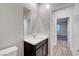 Bathroom featuring a dark vanity, white countertop, and large mirror at 10142 Skye Saddle Ave, Las Vegas, NV 89166