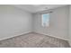 This simple bedroom offers neutral walls, soft carpeting, and a window with a view at 10142 Skye Saddle Ave, Las Vegas, NV 89166