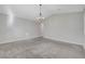 Bedroom with large carpeted area, white walls, and chandelier at 10142 Skye Saddle Ave, Las Vegas, NV 89166