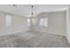 A spacious bedroom featuring neutral paint, carpeted floors, modern lighting, and bright, natural light at 10142 Skye Saddle Ave, Las Vegas, NV 89166